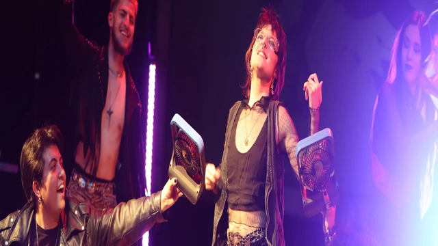 Four actors on set performing a play